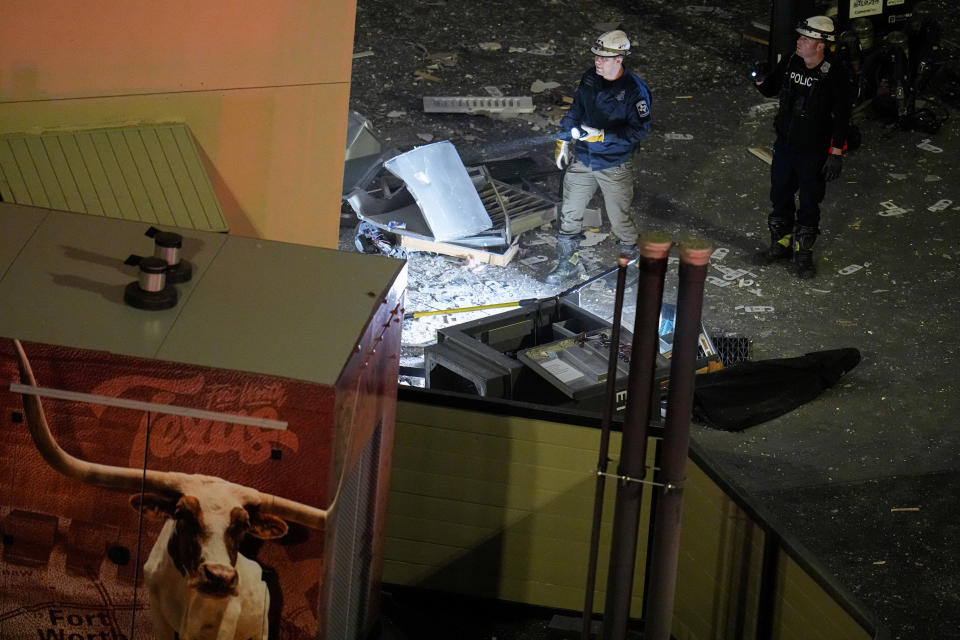 Investigators survey an area near the Sandman Signature hotel following an explosion, Monday, Jan. 8, 2024, in Fort Worth, Texas. (AP Photo/Julio Cortez)