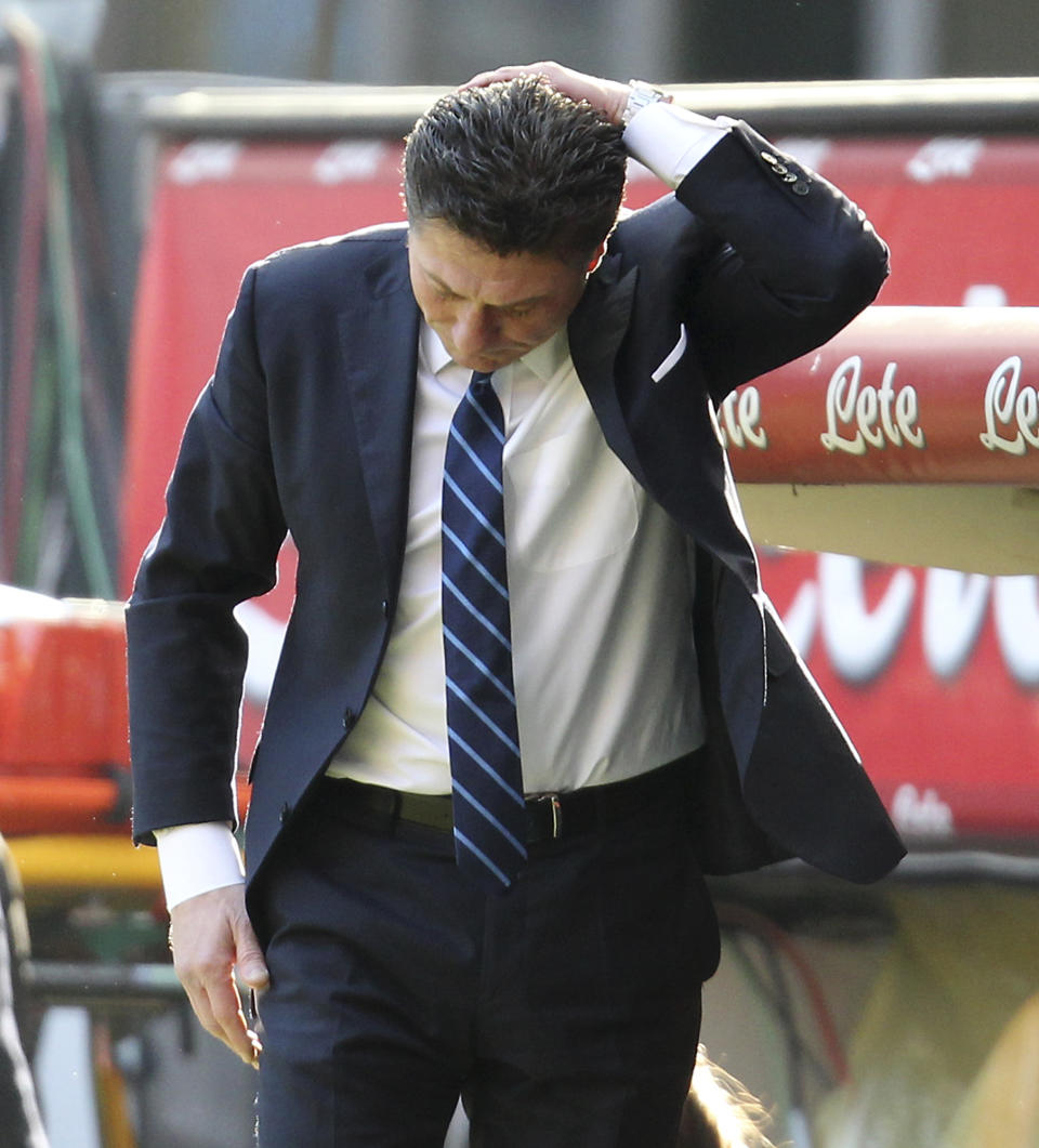 Inter Milan coach Walter Mazzarri touches his head in disappointment during the Serie A soccer match between Inter Milan and Cagliari at the San Siro stadium in Milan, Italy, Sunday, Feb. 23, 2014. (AP Photo/Antonio Calanni)