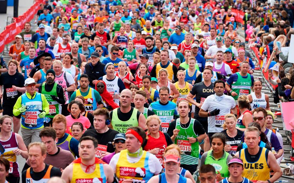 Runners cross Tower Bridge as they take part in the 2016 London Marathon - NIKLAS HALLE'N/AFP via Getty Images