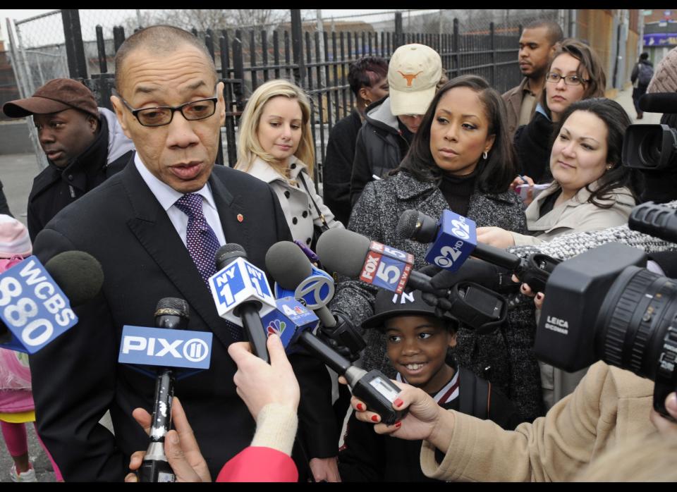 Deputy Mayor Dennis Walcott, left, talks to the media after walking his grandson, Justin, 7, to PS 36-St. Albans School a day after he was nominated by New York City Mayor Michael Bloomberg to replace Cathie Black as schools chancellor, Friday, April 8, 2011 in the Queens borough of New York. (AP Photo/Henny Ray Abrams)