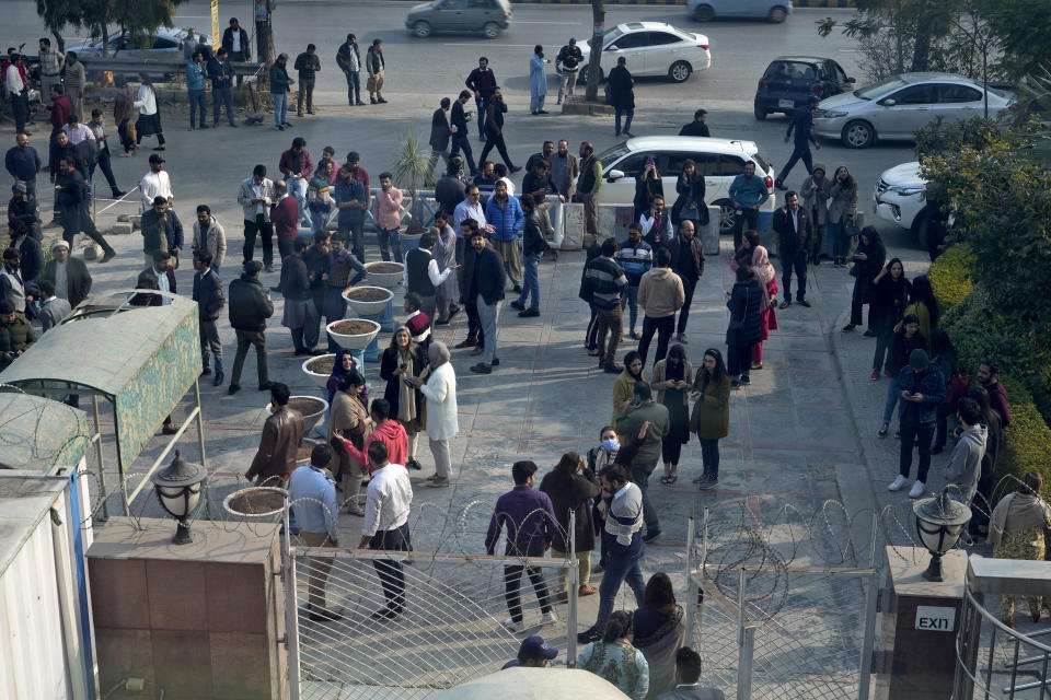 People stand outside their offices building after an earthquake was felt in Islamabad, Pakistan, Thursday, Jan. 11, 2024. A magnitude 6.4 earthquake rattled much of Pakistan and part of neighboring Afghanistan on Thursday, sending panicked residents fleeing from homes and offices and especially frightening people in remote villages across the country, Pakistani officials and the U.S. Geological Survey said. (AP Photo/Anjum Naveed)