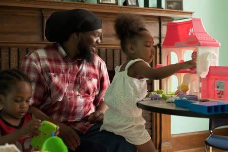 Monae Davis plays with his grandchildren after an interview in Buffalo