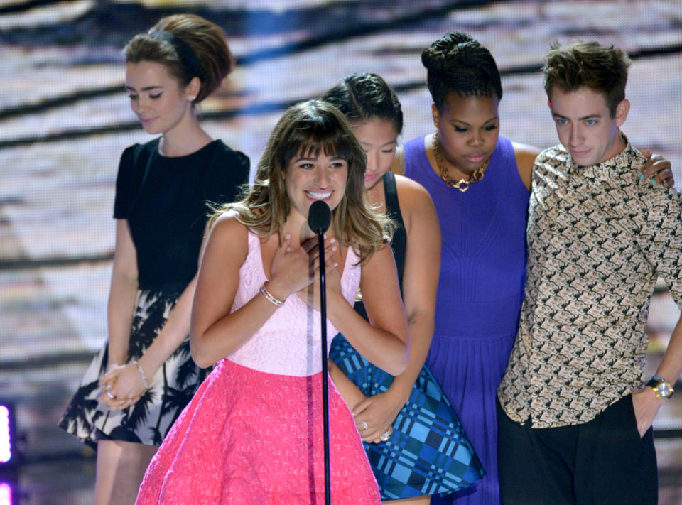 Actress Lea Michele, center, from "Glee"speaks on stage as she accepts an award at the Teen Choice Awards at the Gibson Amphitheater on Sunday, Aug. 11, 2013, in Los Angeles. Pictured in background are fellow cast members, from right, Kevin McHale, Amber Riley, Jenna Ushkowitz and presenter Lily Collins. (Photo by John Shearer/Invision/AP)