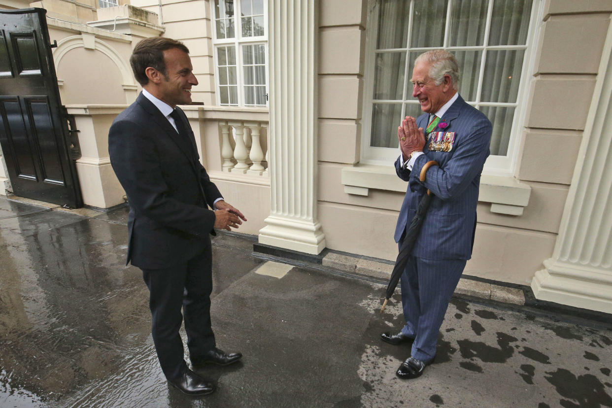 FILE - Britain's Prince Charles welcomes French president Emmanuel Macron, left, to Clarence House in London, Thursday June 18, 2020. French President Emmanuel Macron’s office on Friday, March 24, 2023, said a state visit by Britain’s King Charles III has been postponed amid mass strikes and protests in France. The king had been scheduled to arrive in France on Sunday on his first state visit as monarch, before heading to Germany on Wednesday. (Jonathan Brady/Pool via AP, File)