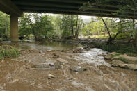 <p>Muddy floodwaters of the East Verde River flow under a bridge where one victim of the flash flood was found during a search and rescue operation by the Gila County Sheriff’s Office on Sunday, July 16, 2017, in Payson, Ariz. (AP Photo/Ralph Freso) </p>