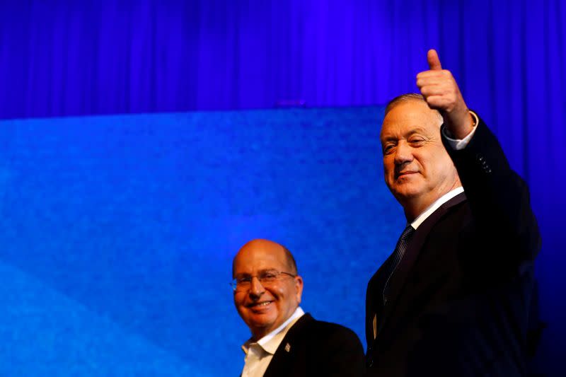 FILE PHOTO: Blue and White party leader Benny Gantz gestures as he stands next to his party co-leader Moshe Yaalon after speaking to supporters following the announcement of exit polls in Israel's election at the party's headquarters in Tel Aviv