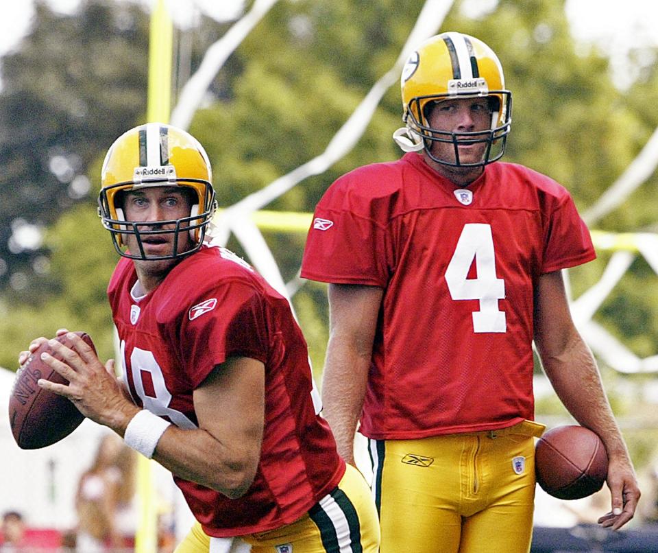 Brett Favre (4) watches Doug Pederson (18) drop back during a Packers practice in 2004. (AP)