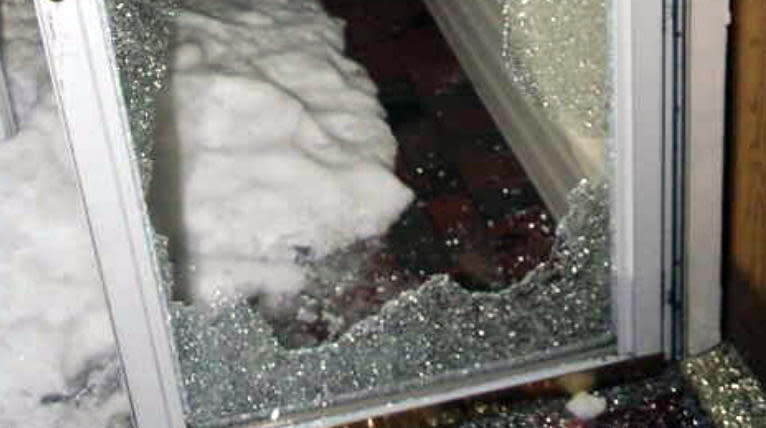 Evidence photo: The shattered glass storm door 