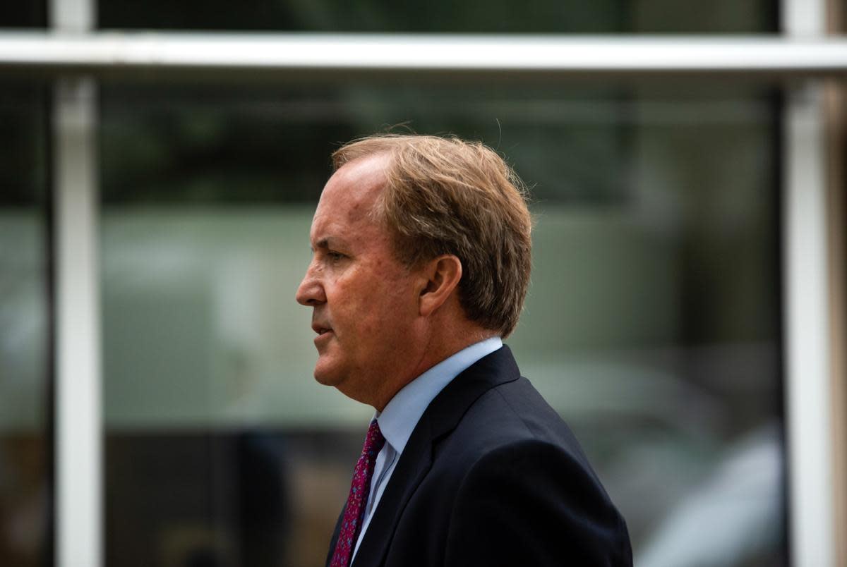 State Attorney General Ken Paxton, right, speaks at a press conference at the Houston Recovery Center on October 26, 2021.