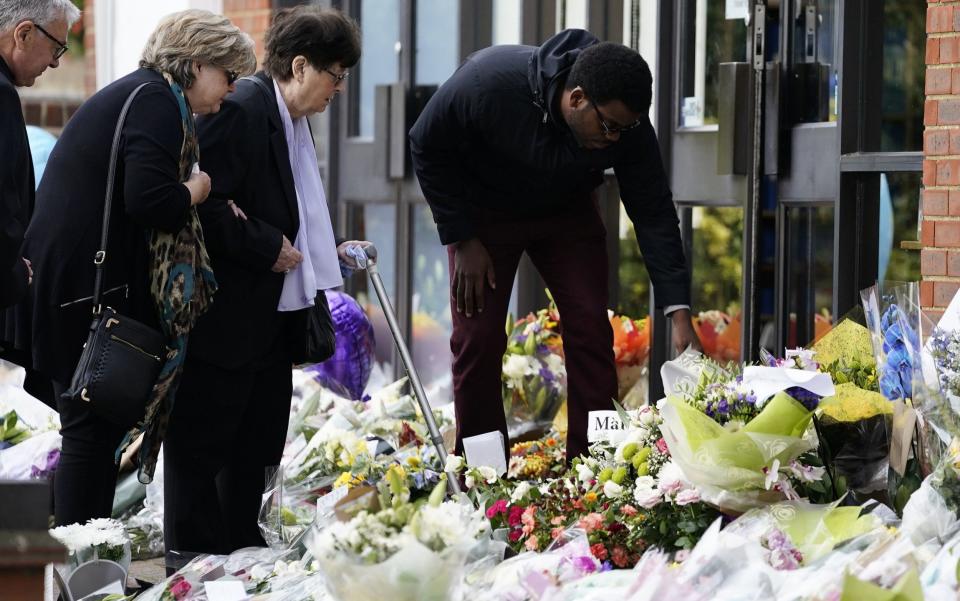 Julia Amess (left) reads tributes to her husband - Aaron Chown/PA