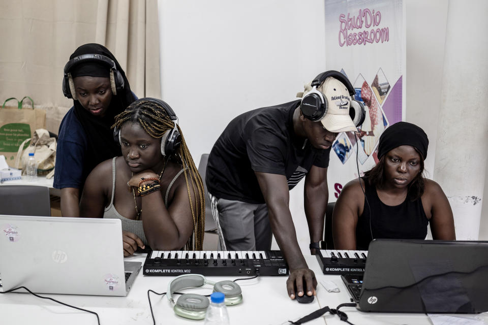 Aminata "Myamy TheAyGirl" Thiam, 31 years-old, left, and Alioune Faye, 29 years -old, right, instruct students at a beat making class for women in Dakar, Senegal, Wednesday, Aug. 14, 2024. Aminata Thiam is Senegal's first female beatmaker. (AP Photo/Annika Hammerschlag)