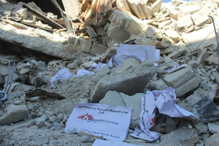 Signs from Doctors Without Borders (MSF) lie amidst debris after a hospital supported by MSF was hit by suspected Russian air strikes near Maaret al-Numan, in Syria's northern province of Idlib, on February 15, 2016