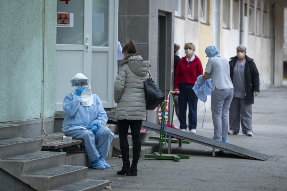 A health worker takes notes at the infectious disease clinic in Zagreb, Croatia, where the first coronavirus case in Croatia is hospitalized, Tuesday, Feb. 25, 2020. Croatia confirmed its first case of coronavirus in a man who had been to Milan, the capital of Lombardy, Italy. (AP Photo/Darko Bandic)