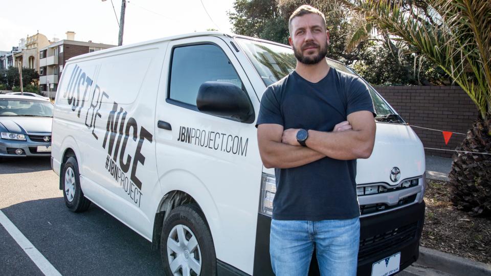 Melbourne man Josh Reid Jones stands in front of his van, which he rents out on Car Next Door.