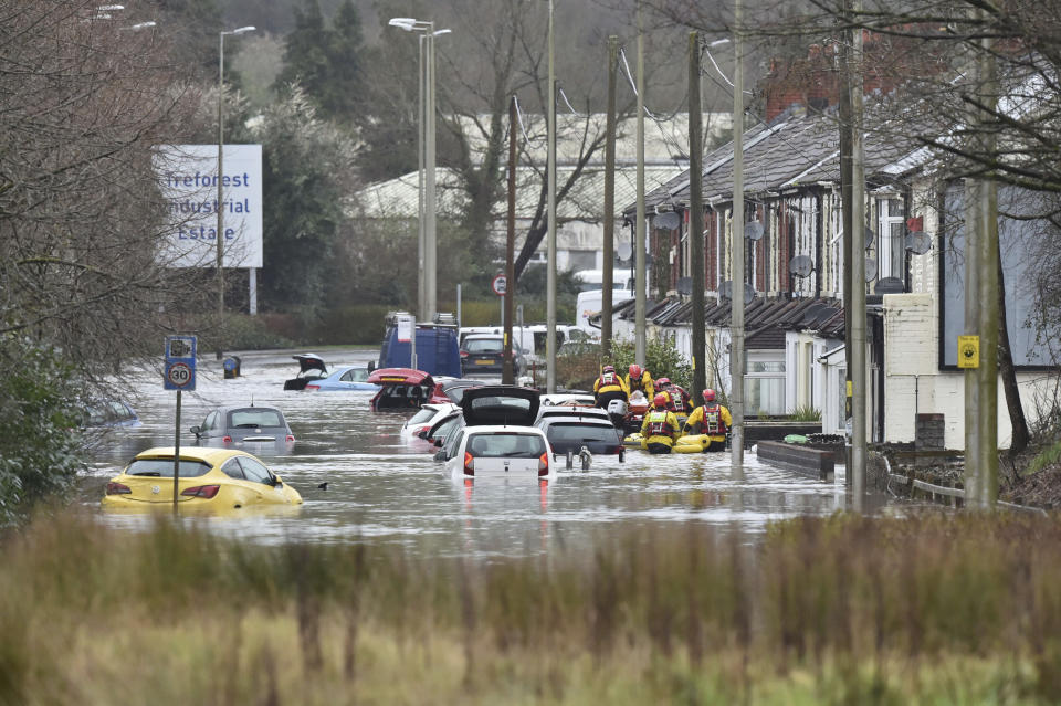 A member of the public is rescued after flooding in Nantgarw, Wales, Sunday, Feb. 16, 2020. Storm Dennis roared across Britain on Sunday, lashing towns and cities with high winds and dumping so much rain that authorities urged residents to protect themselves from “life-threatening floods" in Wales and Scotland. (Ben Birchall/PA via AP)