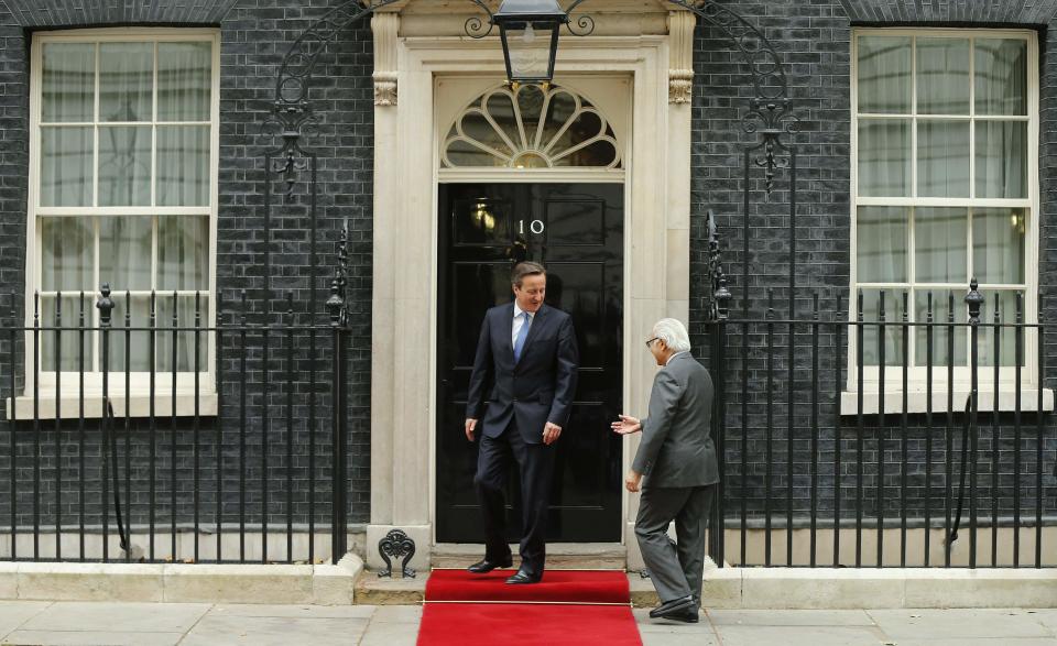 Britain's Prime Minister David Cameron greets the President of Singapore Tony Tan outside Number 10 Downing Street in London