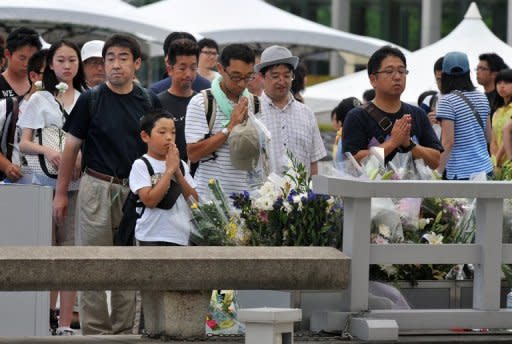 People gather to pray at the memorial for victims of the Hiroshima bombings at the Peace Memorial Park in Hiroshima, Japan