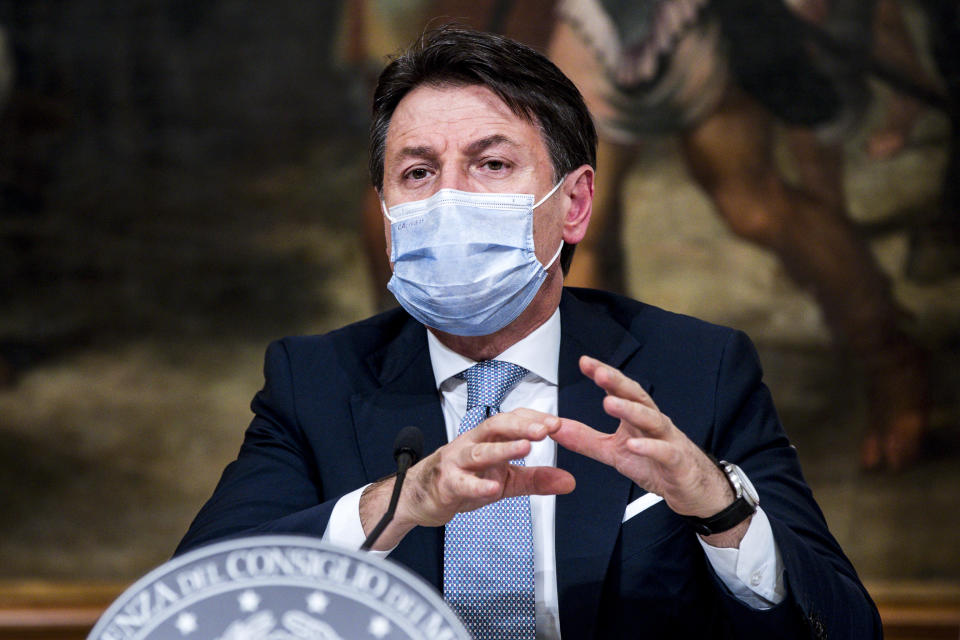 Italian Premier Giuseppe Conte announces new restrictions to curb the spread of coronavirus, in Rome, Wednesday, Nov. 4, 2020. Four regions in Italy are being put under severe lockdown, forbidding people to leave their homes except for essential reasons such as food shopping and work in a bid to slow surging COVID-19 infections and prevent hospitals from being overwhelmed. Premier Giuseppe Conte on Wednesday night announced what he described as “very stringent” restrictions on the so-called “red zone” regions of high risk: Lombardy, Piedmont, Valle d’Aosta in the north and Calabria, the region forming the “toe” in the south of the Italian peninsula. (Angelo Carconi/Pool Photo via AP)