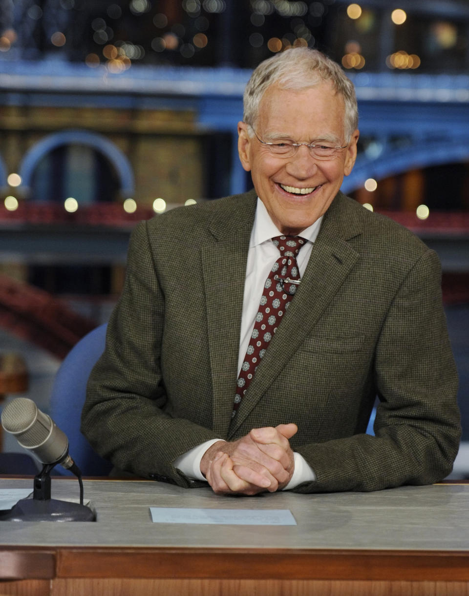 In this photo provided by CBS, David Letterman, host of the “Late Show with David Letterman,” smiles while seated at his desk in New York on Thursday, April 3, 2014. Letterman announced his retirement during Thursday’s taping. Although no specific date was announced he told the audience that he will leave his desk sometime in 2015. (AP Photo/CBS, Jeffrey R. Staab) MANDATORY CREDIT, NO SALES, NO ARCHIVE, FOR NORTH AMERICAN USE ONLY