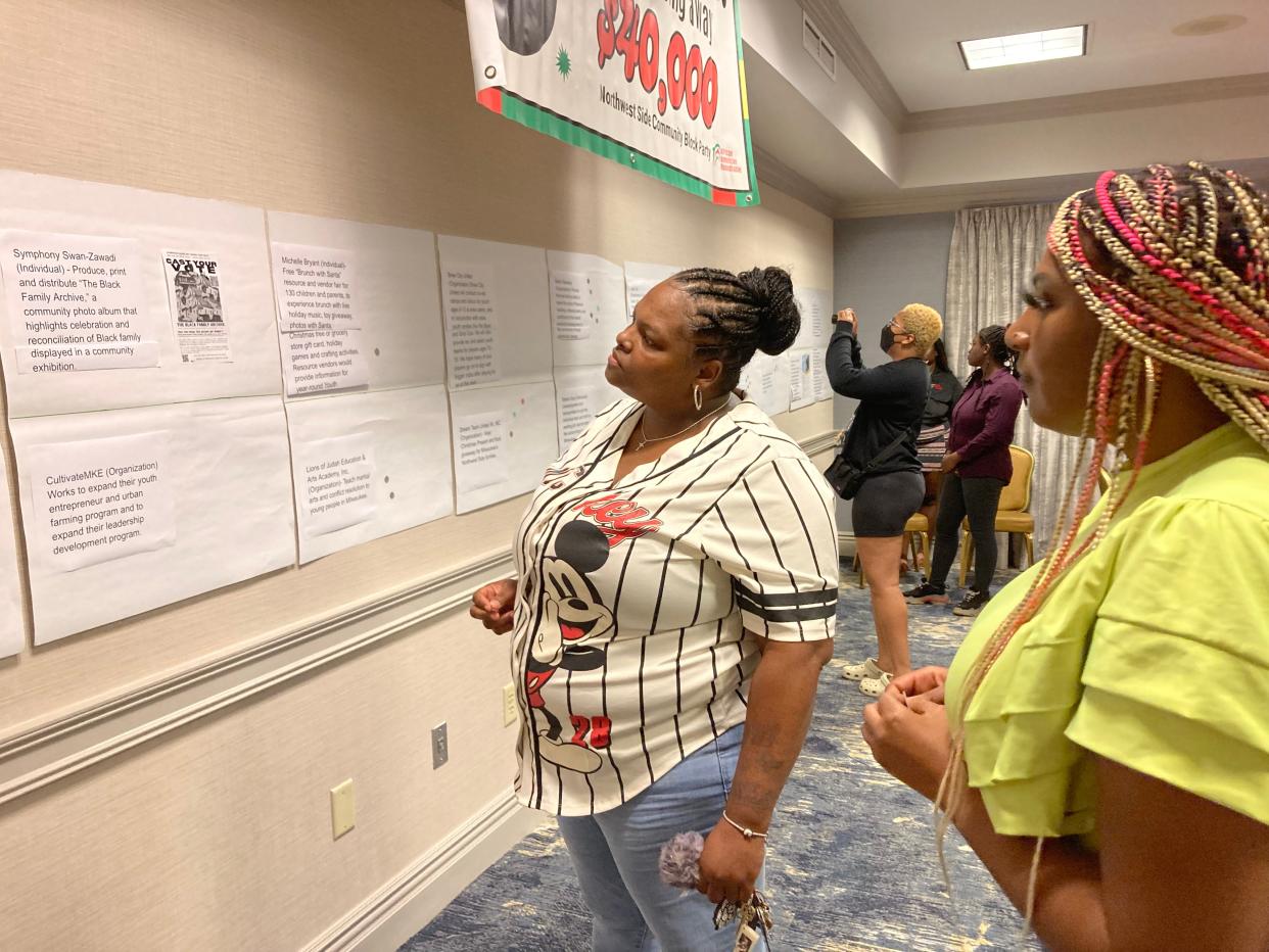 Lisa Davis, 41, looks over proposed community projects seeking funding  from African American Round Table's participatory budgeting project.