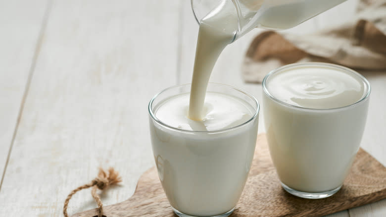 Buttermilk poured from a bottle into a glass