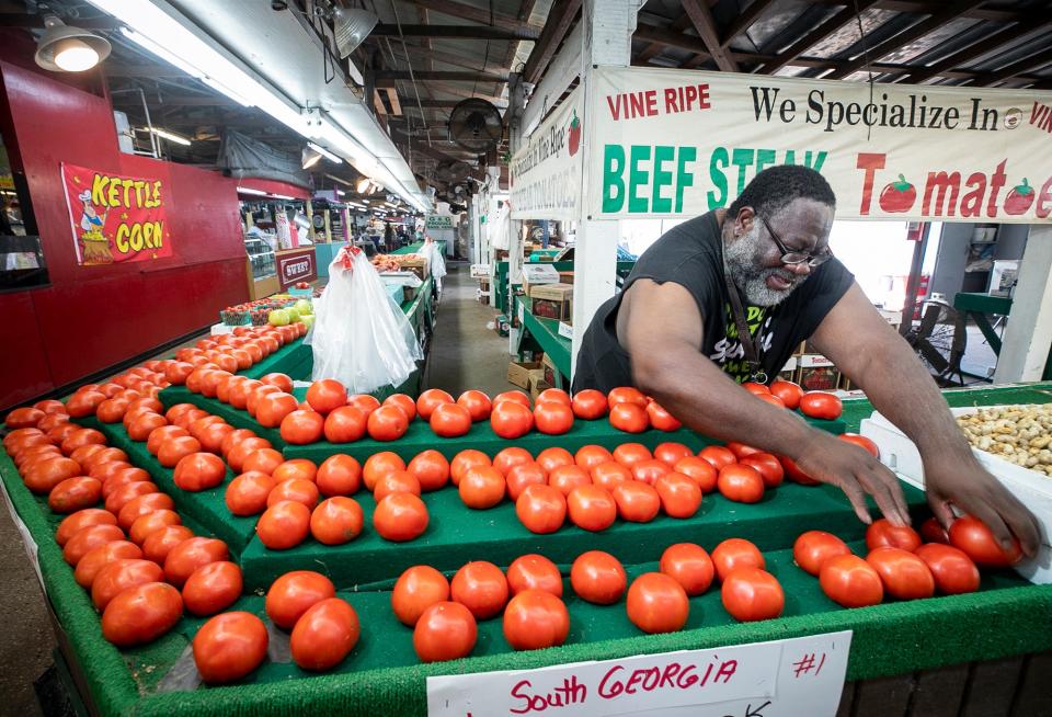 A worker prepares produce for sale at the Daytona Flea & Farmers Market.