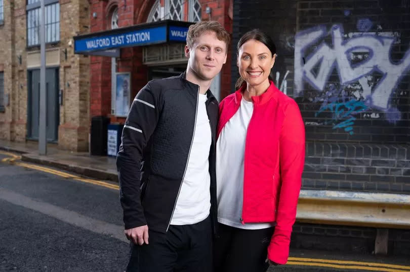 EastEnders Jamie Borthwick and Emma Barton posing on set dressed in running gear