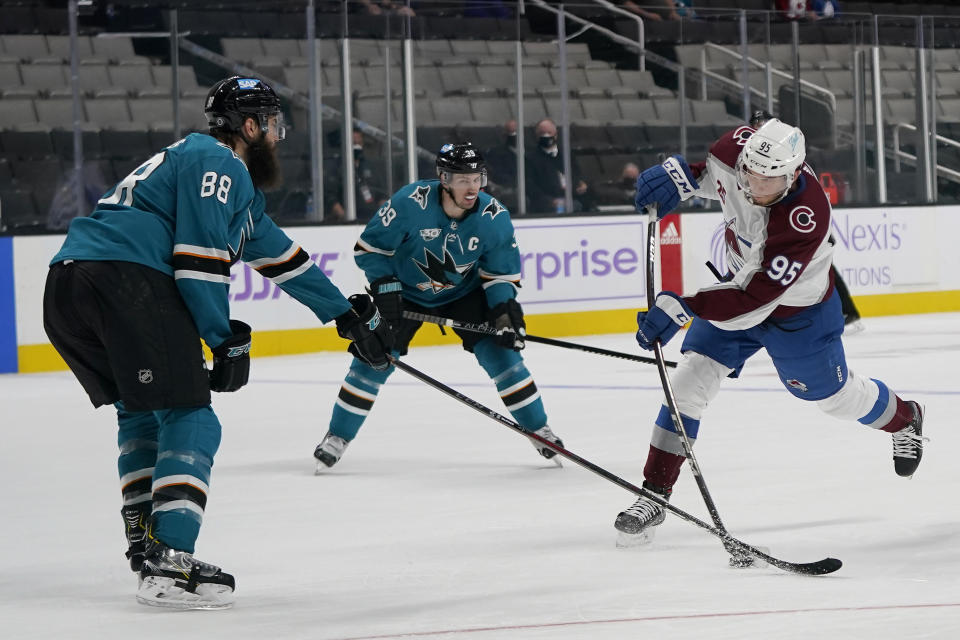 Colorado Avalanche left wing Andre Burakovsky, right, shoots the winning goal against San Jose Sharks defenseman Brent Burns (88) and center Logan Couture (39) during overtime of an NHL hockey game in San Jose, Calif., Monday, May 3, 2021. The Avalanche won, 5-4. (AP Photo/Jeff Chiu)