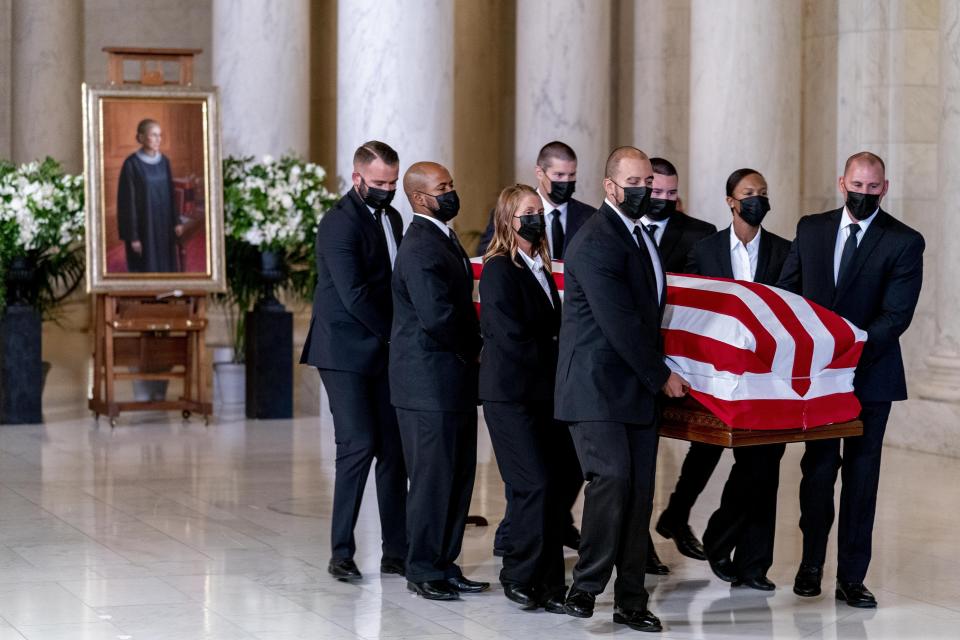 The flag-draped casket of Justice Ruth Bader Ginsburg, carried by Supreme Court police officers, arrives in the Great Hall at the Supreme Court in Washington, Wednesday, Sept. 23, 2020. Ginsburg, 87, died of cancer on Sept. 18. (AP Photo/Andrew Harnik, Pool)