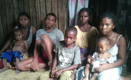 Malagasy fisherman Dada sits with his two sisters, Pela Mainty and Martine, and his wife in Fort Dauphin, Madagascar February 28, 2019. Picture taken February 28, 2019. REUTERS/Rasoanaivo Clarel Faniry