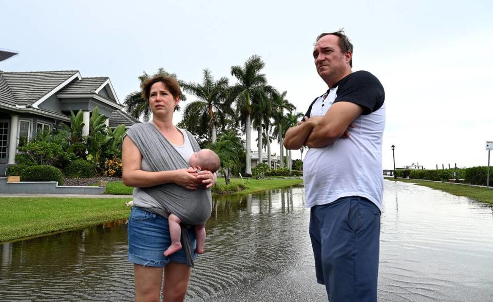 Hailey and Thomas McCoy with their 2-month-old baby Riley take a walk along flooded Riverview Boulevard as Hurricane Idalia approached on August 29, 2023.