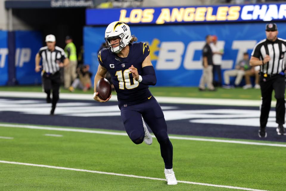 Nov 26, 2023; Inglewood, California, USA; Los Angeles Chargers quarterback <a class="link " href="https://sports.yahoo.com/nfl/players/32676/" data-i13n="sec:content-canvas;subsec:anchor_text;elm:context_link" data-ylk="slk:Justin Herbert;sec:content-canvas;subsec:anchor_text;elm:context_link;itc:0">Justin Herbert</a> (10) runs with a ball during the first quarter against the Baltimore Ravens at SoFi Stadium. Mandatory Credit: Kiyoshi Mio-USA TODAY Sports