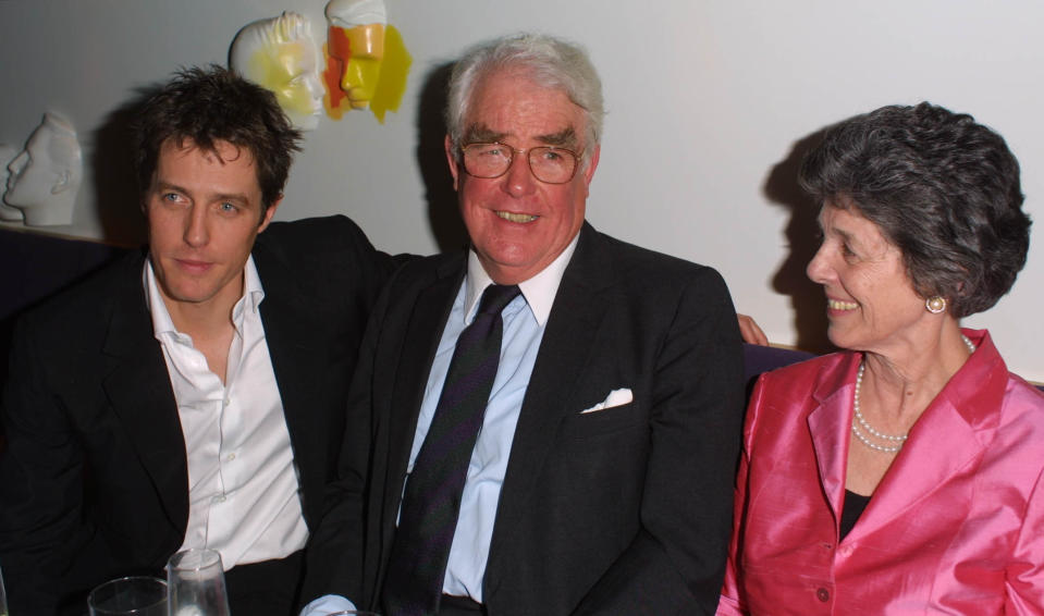 Hugh Grant (L) and parents attend the after-show party for the London premiere of 'Bridget Jones's Diary' at Mezzo, London, April 4, 2001. Grant stars in the film as Bridget Jones's boss and lover Daniel Cleaver. (Photo by Gareth Davies/Getty Images)