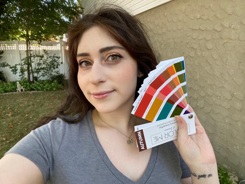 The writer holding an autumn color wheel