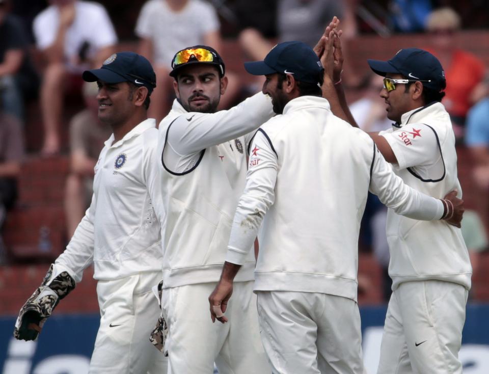 India's players celebrate the dismissal of New Zealand's Kane Williamson during day one of the second international test cricket match at the Basin Reserve in Wellington, February 14, 2014.