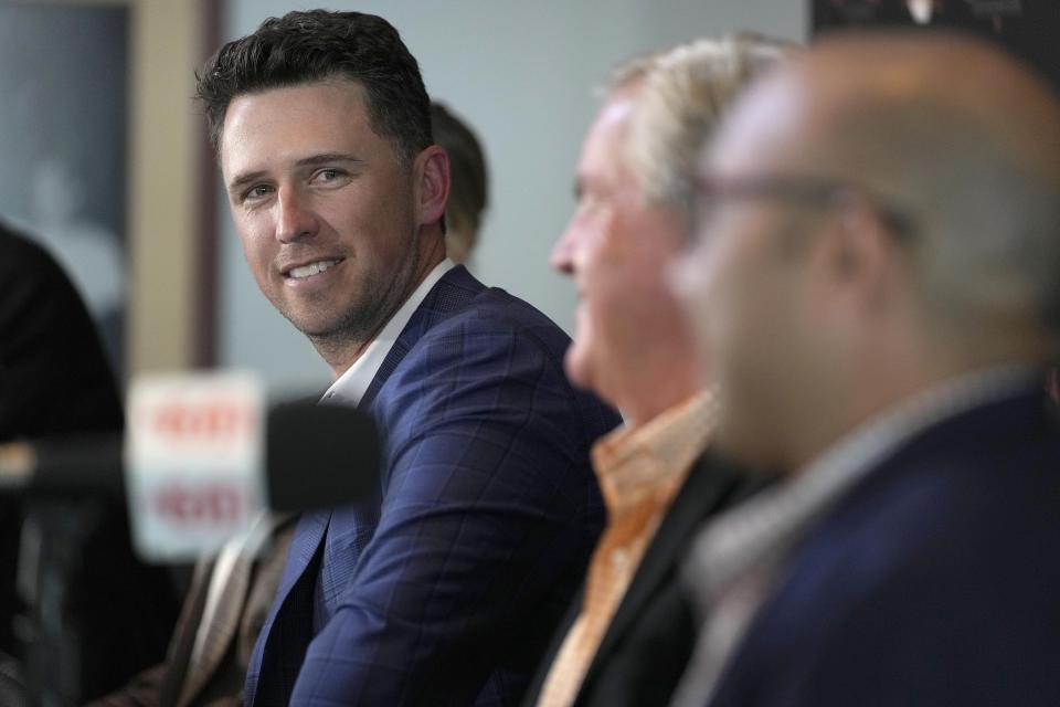 San Francisco Giants catcher Buster Posey smiles during a news conference announcing his retirement from baseball, Thursday, Nov. 4, 2021, in San Francisco. (AP Photo/Tony Avelar)