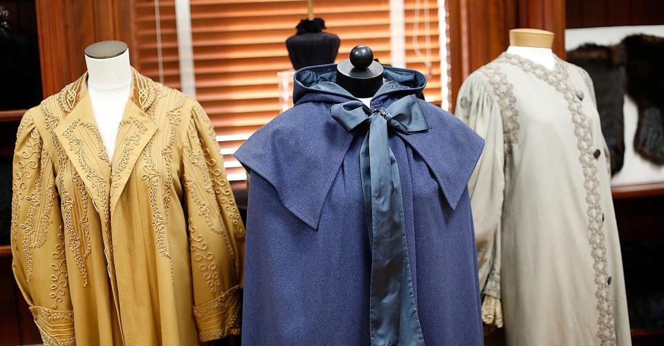 In the center is an 1895 wool Quaker cloak manufactured by E.J. Neale Co., a Quaker business started by Sister Emma Neale of the Mount Lebanon Church Family. It is part of the "Baby, It's Cold Outside" exhibit at Cohasset Historical Society. Wednesday Jan. 17, 2024.