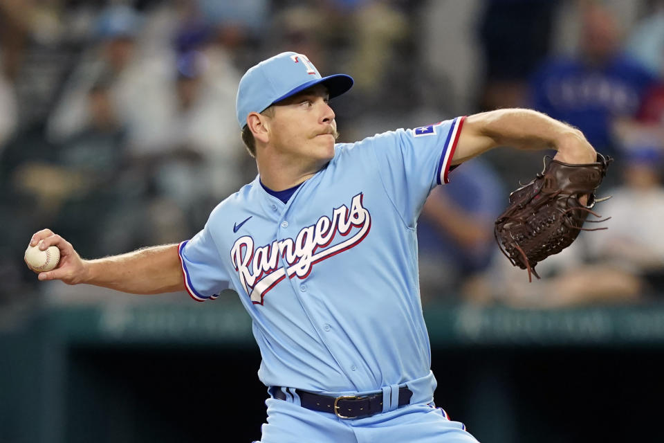 Texas Rangers starting pitcher Spencer Howard throws during the first inning of a baseball game against the Chicago White Sox in Arlington, Texas, Sunday, Aug. 7, 2022. (AP Photo/LM Otero)