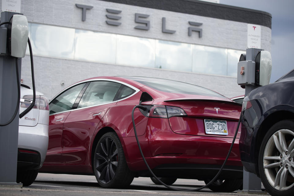 In this Sunday, June 27, 2021, photograph, a 2021 Model 3 sedan sits in a near-empty lot at a Tesla dealership in Littleton, Colo. A build-to-order vehicle from the factory ensures you get the exact car, color and option combination that you want. It&#x002019;s a little-known method to save time tracking down a vehicle that fits your needs. (AP Photo/David Zalubowski)