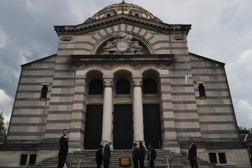 Paris undertaker Franck Vasseur, right and pallbearer, Louis Mercier, left, attend a funeral ceremony for of an 83-year-old man, at Pere Lachaise cemetery in Paris, Friday, April 24, 2020 as a nationwide confinement continues to counter the COVID-19 virus. (AP Photo/Francois Mori)