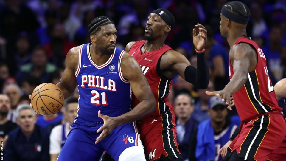 Joel Embiid of the Philadelphia 76ers is guarded by Bam Adebayo of the Miami Heat