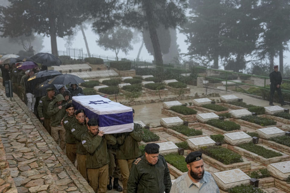 Israeli soldiers carry the flag-draped casket of reservist Elkana Vizel during his funeral at Mt. Herzl military cemetery in Jerusalem, Tuesday, Jan. 23, 2024. Vizel, 35, was killed during Israel's ground operation in the Gaza Strip, where the Israeli army has been battling Palestinian militants in the war ignited by Hamas' Oct. 7 attack into Israel. (AP Photo/Ohad Zwigenberg)