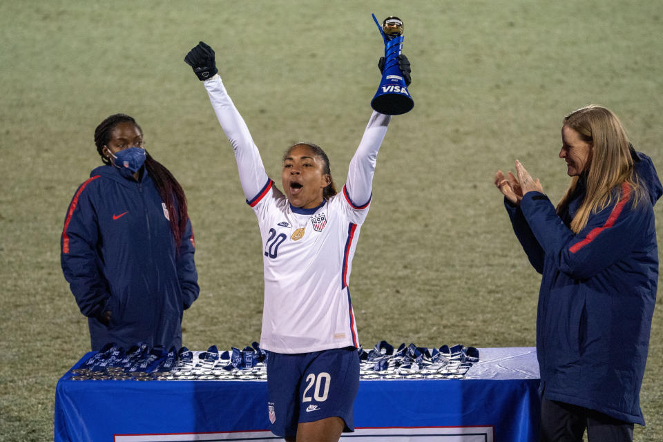 U.S. forward Catarina Macario holds up the SheBelieves Cup MVP trophy after the team's 5-0 victory over Iceland in a soccer match Wednesday, Feb. 23, 2022, in Frisco, Texas. (AP Photo/Jeffrey McWhorter)