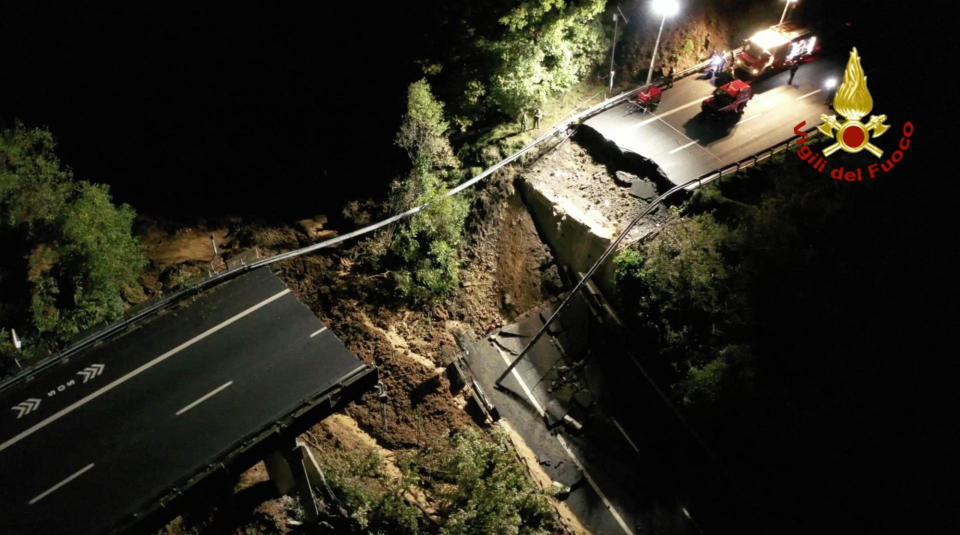 This picture made available Monday, Nov. 25, 2019 shows the collapsed stretch of the Turin to Savona A6 highway, which plunged into a wooded area of the Liguria region Sunday, Nov. 24, 2019 following heavy rains. Flooding pounded France and Italy amid heavy rains over the weekend, leaving at least three dead and a stretch of elevated highway collapsed by a landslide, officials said Sunday. (Vigili del Fuoco via AP)
