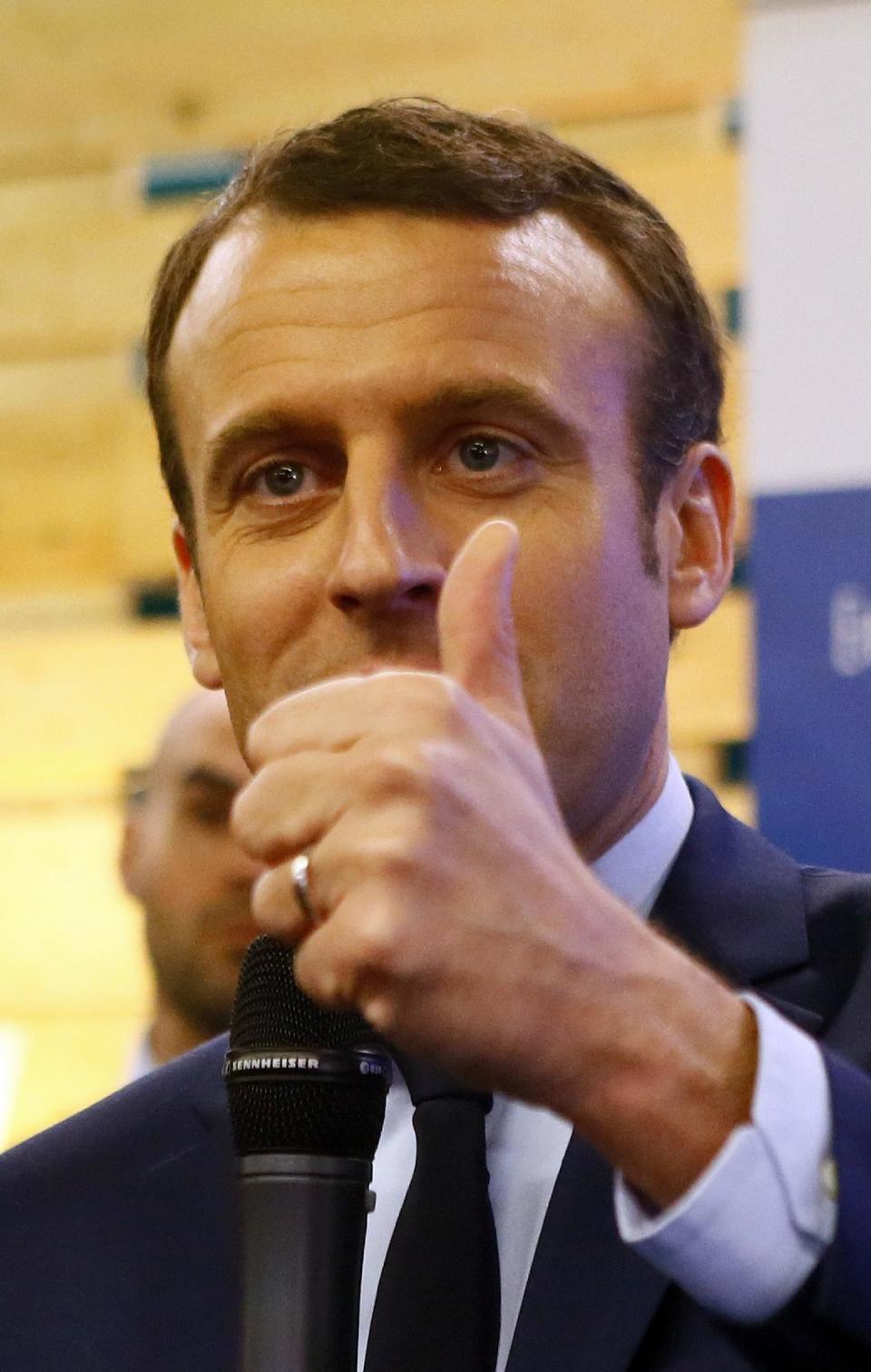 Presidential candidate Emmanuel Macron thumbs up at the Entrepreneurs Fair in Paris, Thursday, Feb. 2, 2017. With French President Francois Hollande having abandoned hopes of a second five-year term and conservative candidate Francois Fillon weakened, National Front leader Marine Le Pen and independent maverick candidate Macron are making hay. (AP Photo/Francois Mori)
