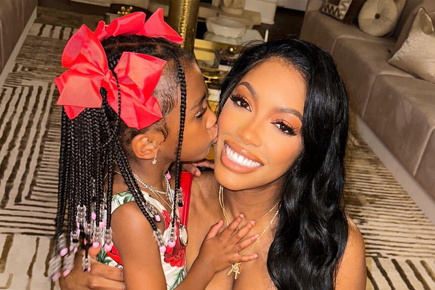 Pilar Jhena kissing her mom, Porsha Williams on the cheek.