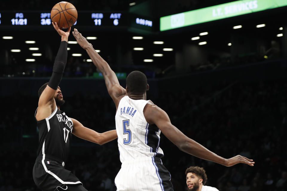 Orlando Magic center Mo Bamba (5) defends as Brooklyn Nets guard Garrett Temple (17) goes up to shoot during the first half of an NBA basketball game Monday, Feb. 24, 2020, in New York. (AP Photo/Kathy Willens)