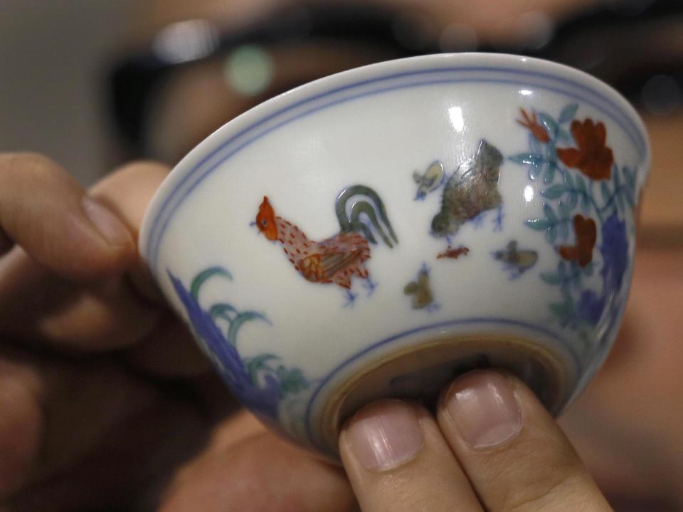 The Meiyintang “Chicken Cup” from the Chinese Ming Dynasty (1368-1644) is displayed during a press conference in Hong Kong, Tuesday, April 8, 2014. Sotheby’s said Shanghai collector Liu Yiqian won the bidding for the “Chicken Cup,” which is decorated with a rooster, hen and their chicks. Including the auction house’s commission, the price for the small cup comes to HK$281.2 million (US$36.1 million), which Sotheby’s said is a world record price for Chinese porcelain. (AP Photo/Vincent Yu)