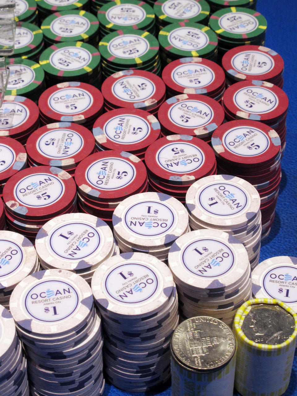 In this June 18, 2019 photo, gambling chips sit on a a gaming table at the Ocean Casino Resort in Atlantic City, N.J. How to keep chips clean is one of many issues with which U.S. casinos are grappling as they prepare to reopen after shutdowns due to the coronavirus outbreak. (AP Photo/Wayne Parry)