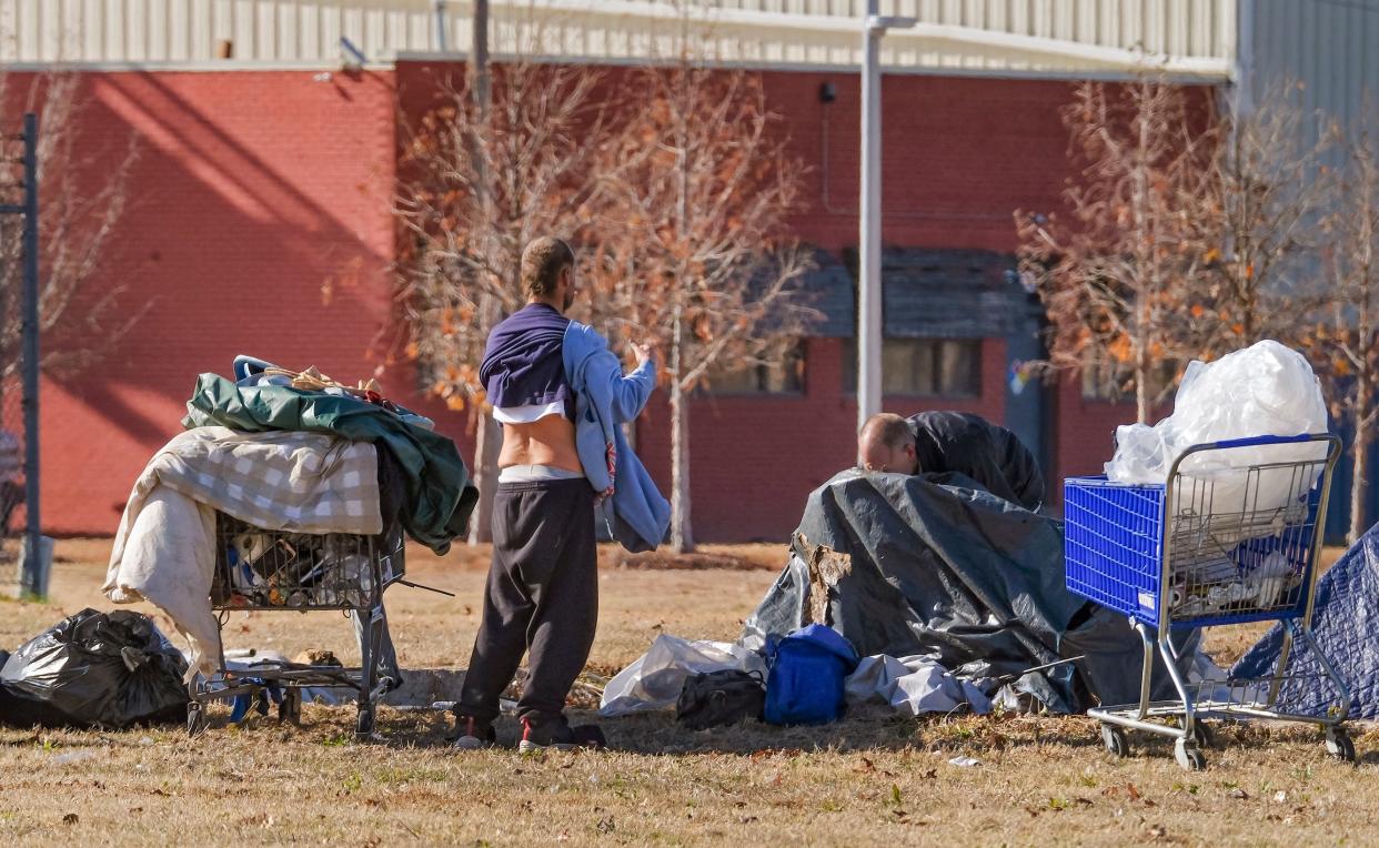 A group of homeless people is pictured Dec. 11 along Reno Avenue between Dewey and Lee. The group was just moved out of a space in the corner of the field.